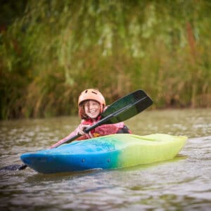 A student kayaking in the river