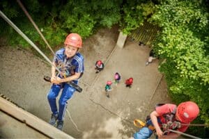 Two boys abseiling down