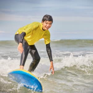 A student surfing in the sea