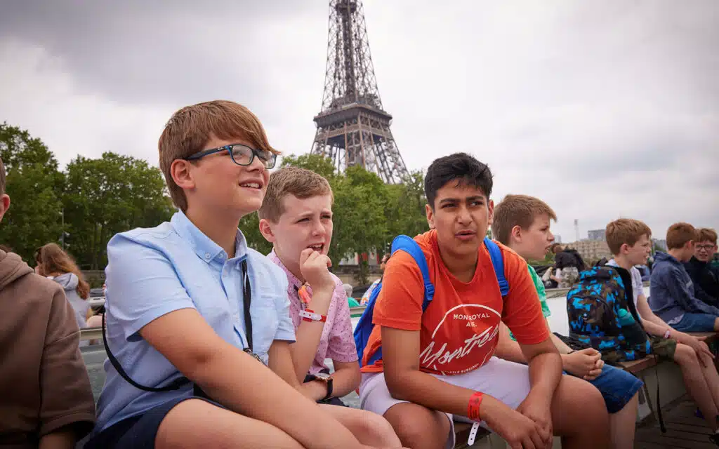 Group posing for a photograph in front of the Eiffel Tower on a PGL French package holiday.