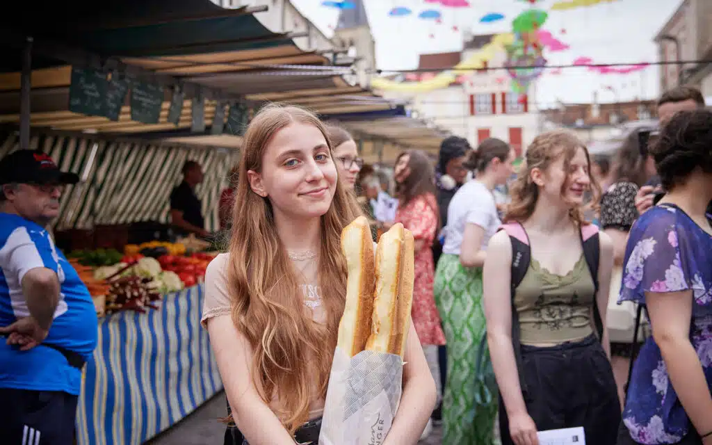 Students shopping at a French market on a PGL trip