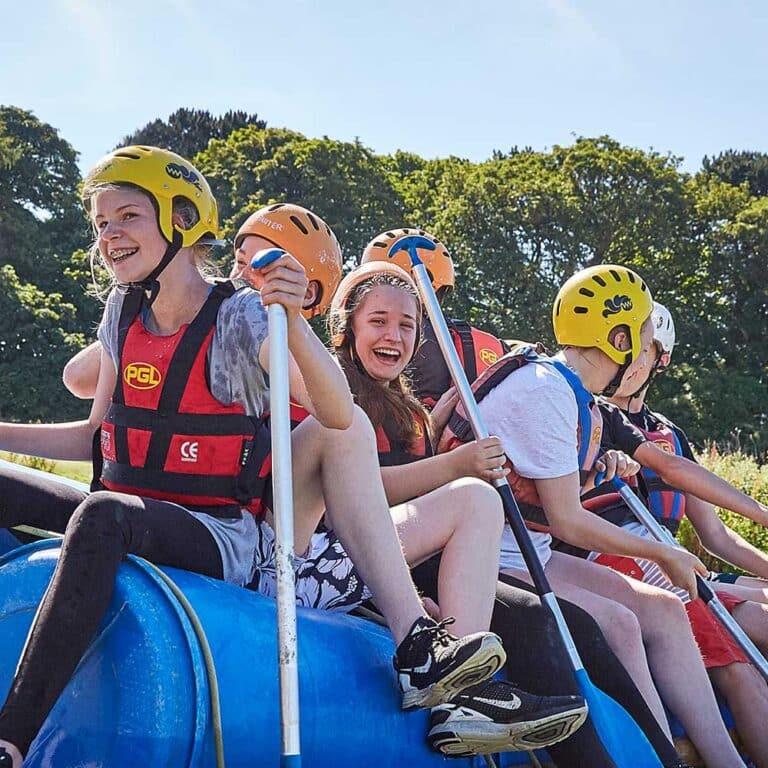 Secondary schools residential trip students on the raft they made competing against other teams