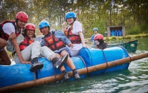 Group sitting on a home-made raft.