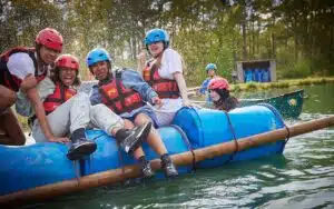 Students sitting on a home-made raft.