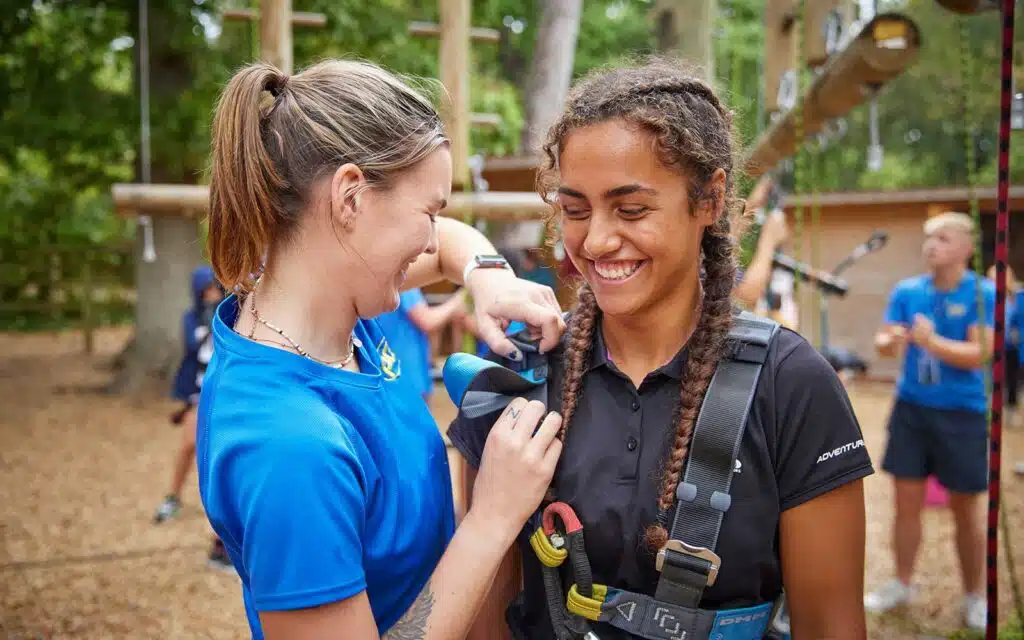 Student getting a harness fitted by a PGL instructor.