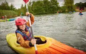 Child kayaking on the lake as part of a multi-activity weekend