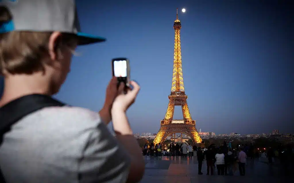 Student taking a photograph of the Eiffel Tower