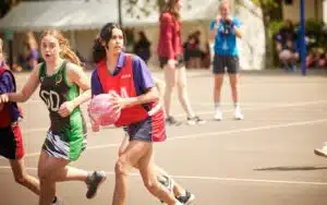 Two girls playing netball