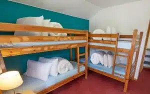 2 bunkbeds with pillows and duvets
