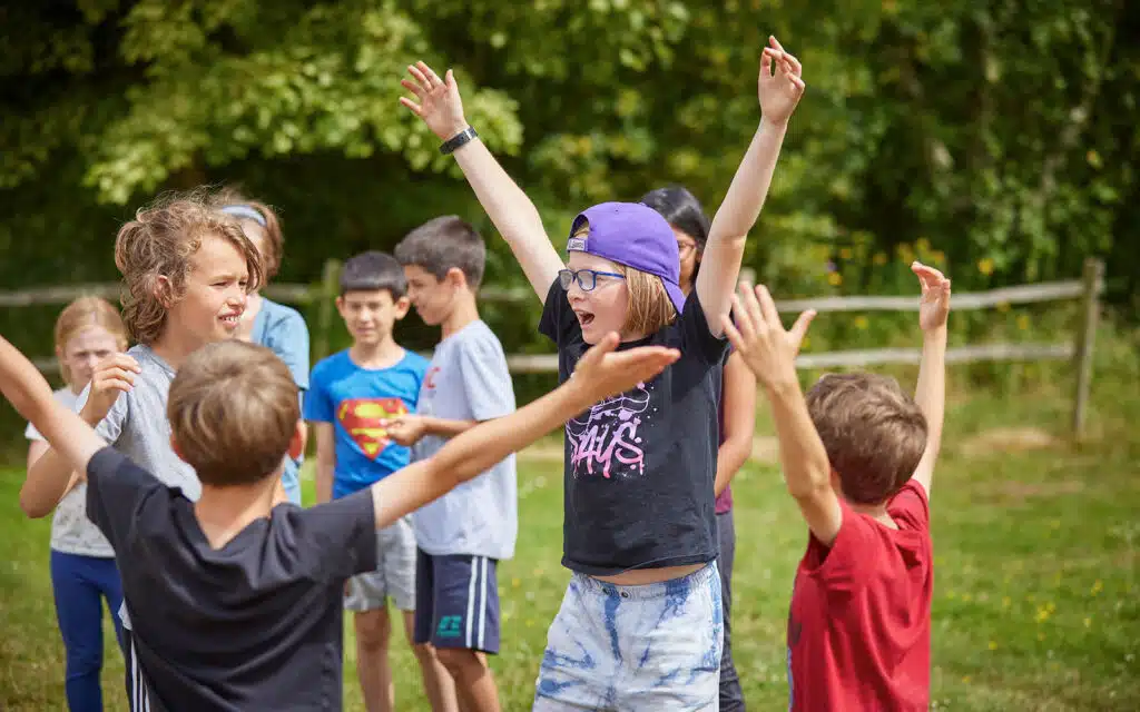 A group of kids with their arms in the air