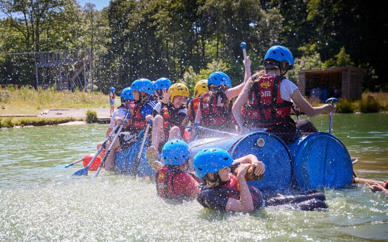 Kids doing a river raft challenge