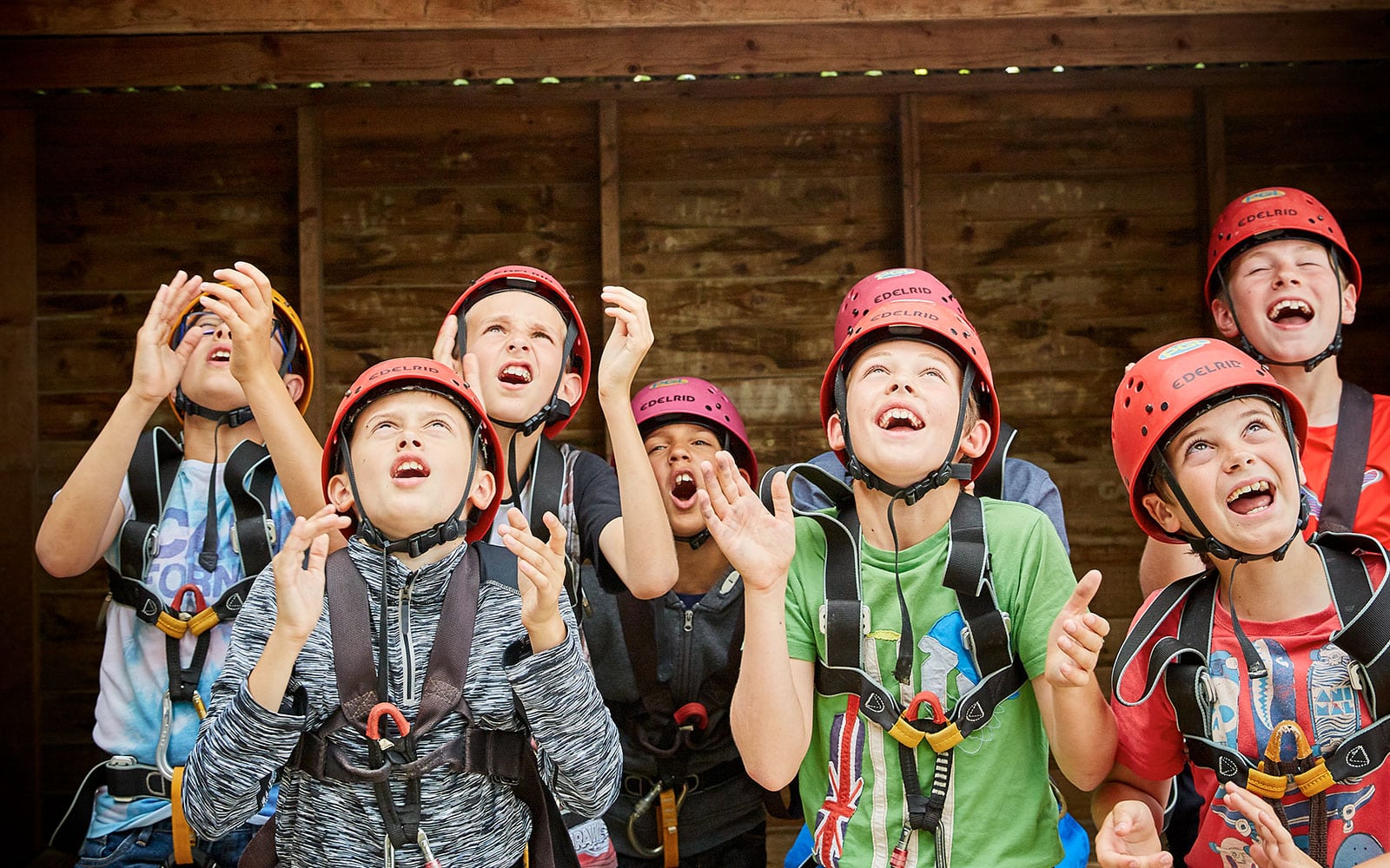 School group encouraging a friend climbing