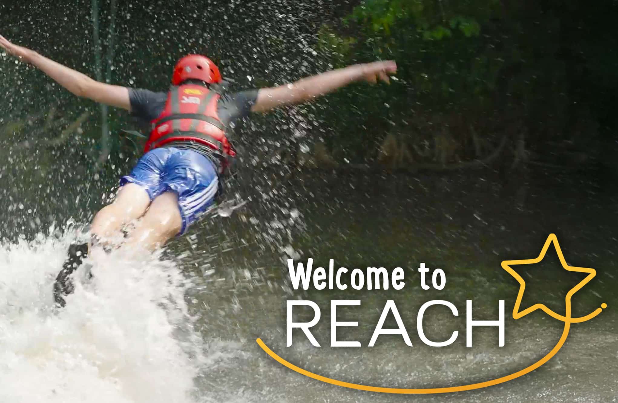 Person in a red helmet and life jacket falling backward into water with arms outstretched. Text reads, "Welcome to REACH" with a star graphic.