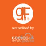 Gluten free symbol with text: "accredited by Coeliac UK live well gluten free" on an orange background.