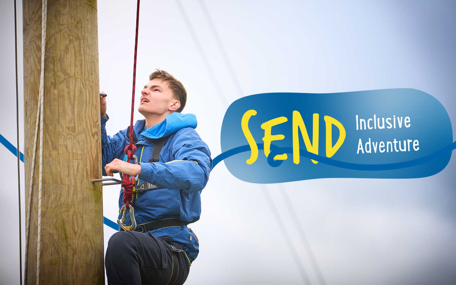 A young person wearing a harness climbs an outdoor wooden pole. Text overlay reads “SEND Inclusive Adventure”.