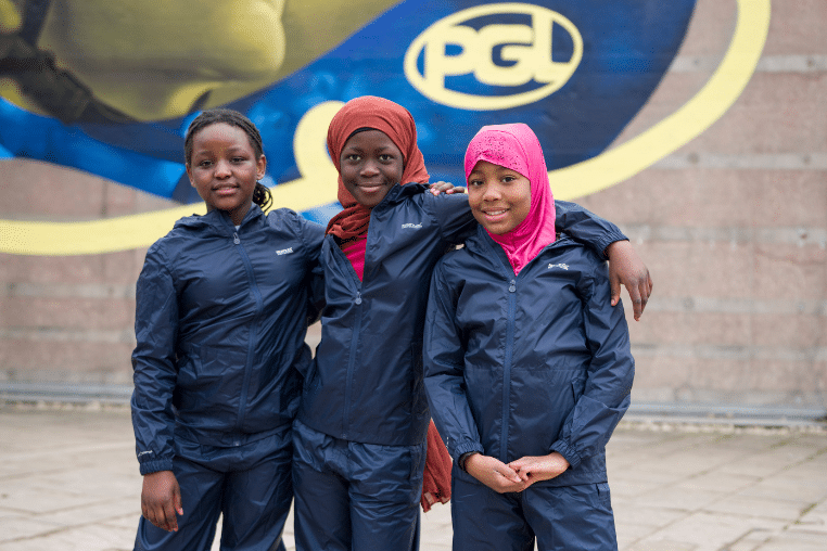 Three smiling children wearing Regatta waterproof clothing