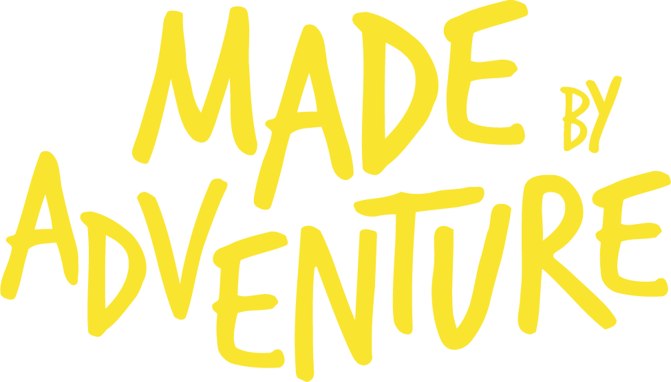 Yellow text in a handwritten style reads "MADE BY ADVENTURE" on a light background, perfectly capturing the spirited energy of PGL camps.
